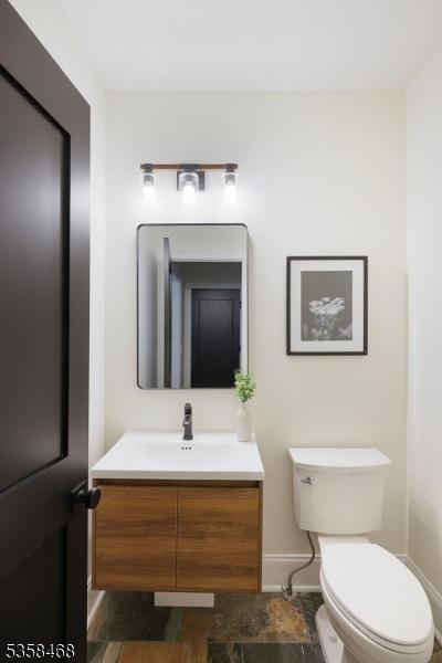 237 Appletree Ln, Mountainside Boro, NJ 07092 - half bath featuring vanity, toilet, baseboards, and stone finish floors