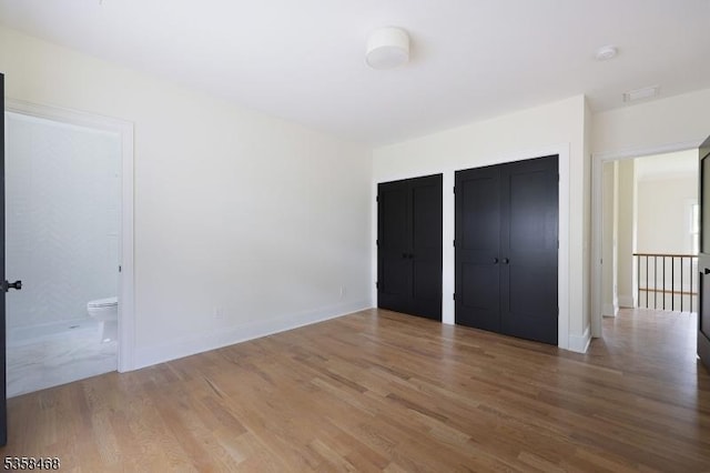 237 Appletree Ln, Mountainside Boro, NJ 07092 - unfurnished bedroom featuring wood finished floors, multiple closets, baseboards, and ensuite bath