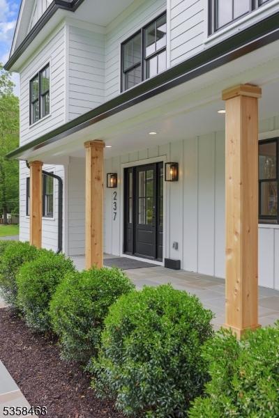 237 Appletree Ln, Mountainside Boro, NJ 07092 - property entrance with board and batten siding and a porch