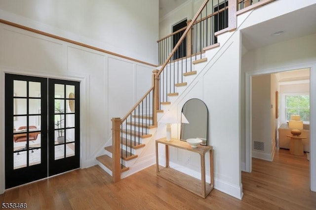 237 Appletree Ln, Mountainside Boro, NJ 07092 - foyer with french doors, light wood-type flooring, a decorative wall, and stairway
