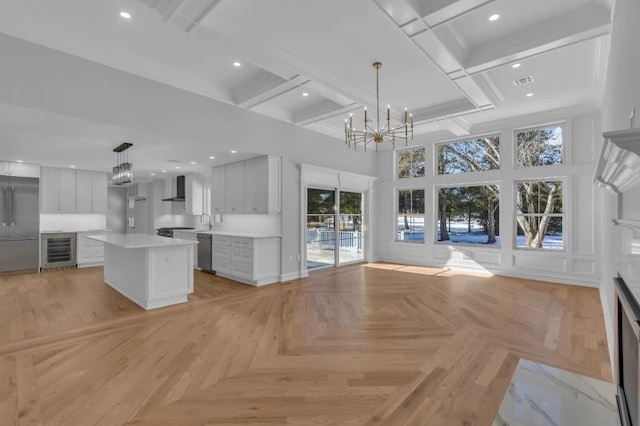 737 Wingate Dr, Bridgewater Twp, NJ 08807 - kitchen with wall chimney exhaust hood, wine cooler, a chandelier, dishwasher, and healthy amount of natural light