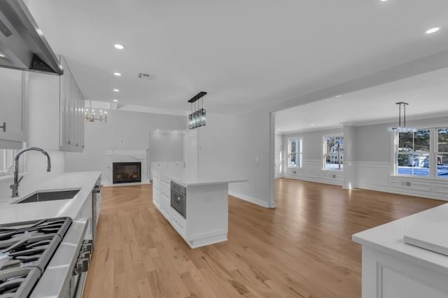 737 Wingate Dr, Bridgewater Twp, NJ 08807 - kitchen with open floor plan, wall chimney range hood, a sink, light countertops, and recessed lighting