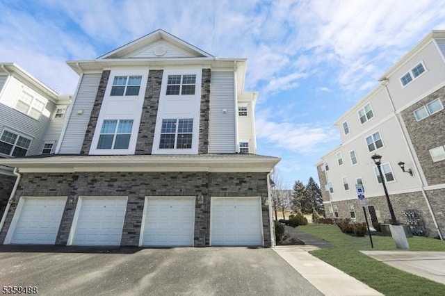 view of front of home with an attached garage and asphalt driveway