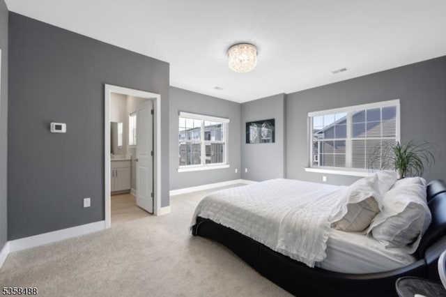bedroom featuring baseboards, light carpet, and a chandelier