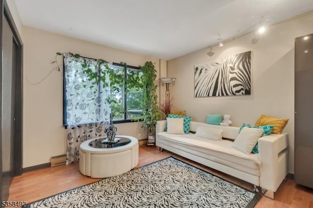 1178 Johnston Dr, Watchung Boro, NJ 07069 - living area featuring wood finished floors, a baseboard radiator, and rail lighting