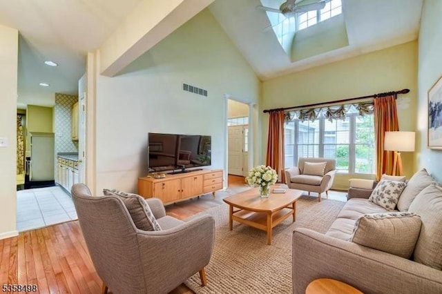 4 Loft Dr, Bridgewater Twp, NJ 08836 - living area with plenty of natural light, a high ceiling, ceiling fan, a skylight, and light wood finished floors