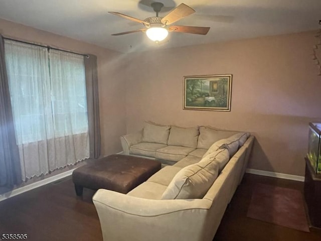 living room with a ceiling fan, wood finished floors, and baseboards