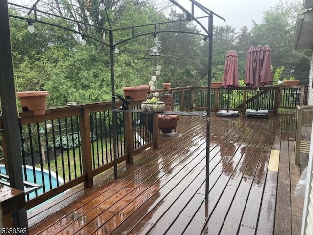 wooden deck featuring an outdoor pool