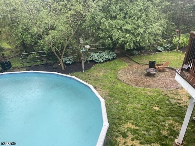 view of swimming pool with an outdoor fire pit