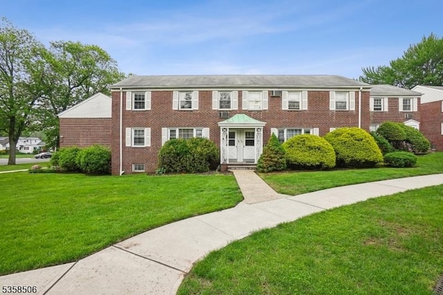 view of front of house featuring a front yard and brick siding