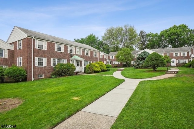 view of property's community with a lawn and a residential view