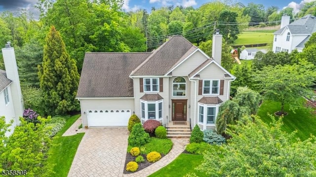 2 Jolie Ct, Boonton Town, NJ 07005 - view of front of house with an attached garage, a chimney, and driveway