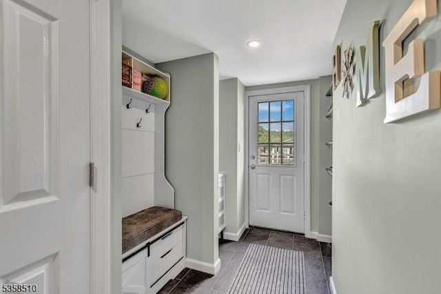 mudroom with baseboards, dark tile patterned floors, and recessed lighting