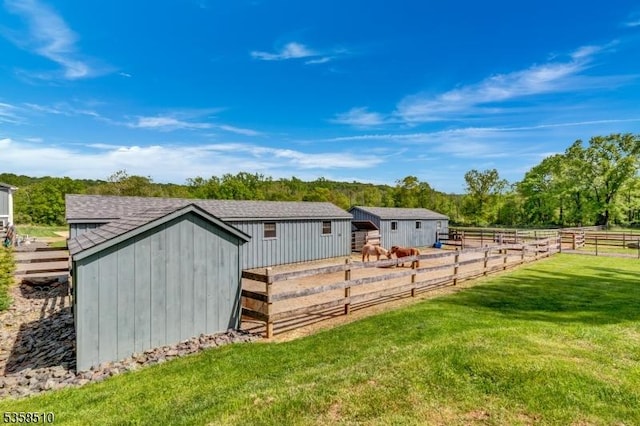 view of grassy yard with an outbuilding and a storage shed