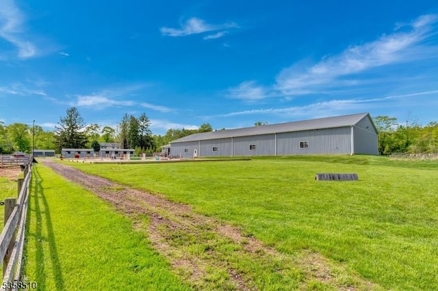 view of yard with a pole building and an outbuilding