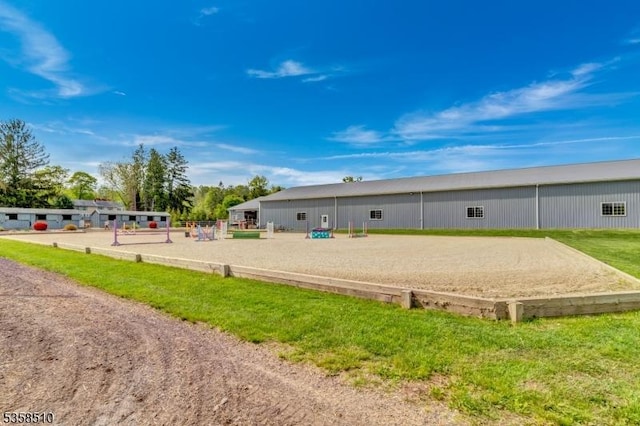 rear view of property with an enclosed horse arena