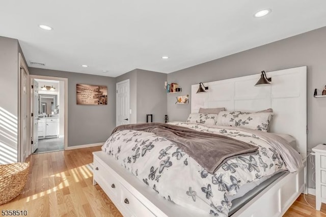 bedroom featuring light wood-style floors, recessed lighting, baseboards, and connected bathroom