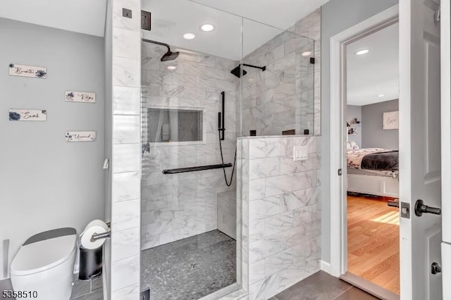 bathroom featuring connected bathroom, a shower stall, recessed lighting, and toilet