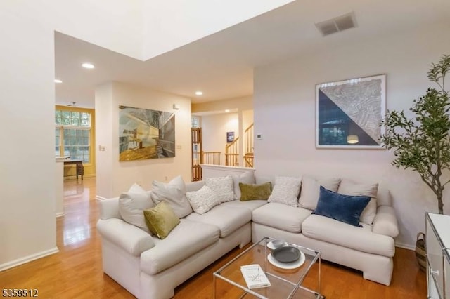 618 Turlington Ct, Livingston Twp, NJ 07039 - living area with light wood-type flooring, stairway, baseboards, and recessed lighting