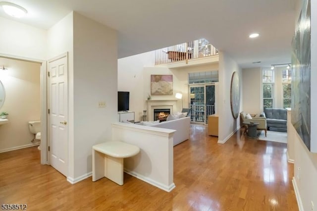 618 Turlington Ct, Livingston Twp, NJ 07039 - living area with a lit fireplace, wood finished floors, baseboards, and recessed lighting