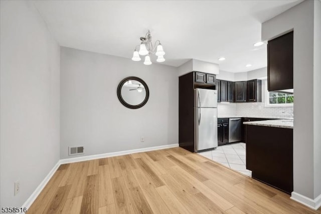 24 Stevens Ct, Bedminster Twp, NJ 07921 - kitchen featuring stainless steel appliances, a chandelier, light wood-style flooring, decorative backsplash, and recessed lighting
