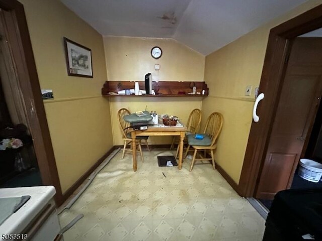 office with light flooring, vaulted ceiling, and baseboards