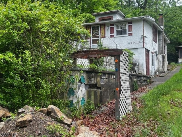 view of front facade featuring a chimney