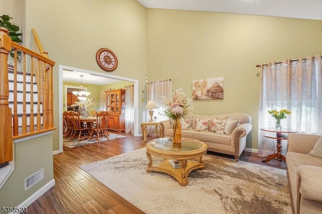 40 Nathan Dr, Old Bridge Twp, NJ 08857 - living room featuring stairs, high vaulted ceiling, wood finished floors, a chandelier, and baseboards