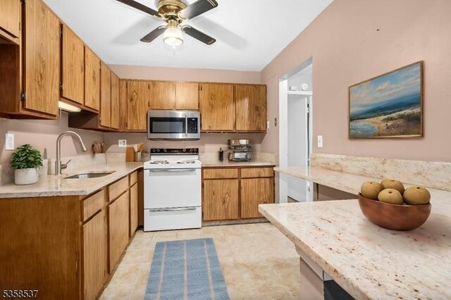 35 E Price St Unit 5, Linden City, NJ 07036 - kitchen featuring stainless steel microwave, white electric stove, a sink, a ceiling fan, and brown cabinetry