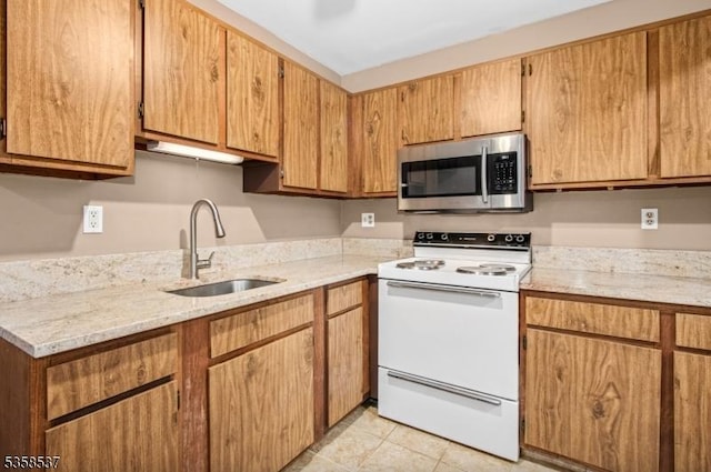 35 E Price St Unit 5, Linden City, NJ 07036 - kitchen with stainless steel microwave, electric stove, a sink, light tile patterned floors, and light stone countertops