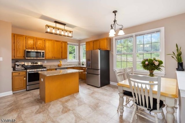 104 Hockenbury Dr, Glen Gardner Boro, NJ 08826 - kitchen featuring stainless steel appliances, a center island, hanging light fixtures, baseboards, and brown cabinetry