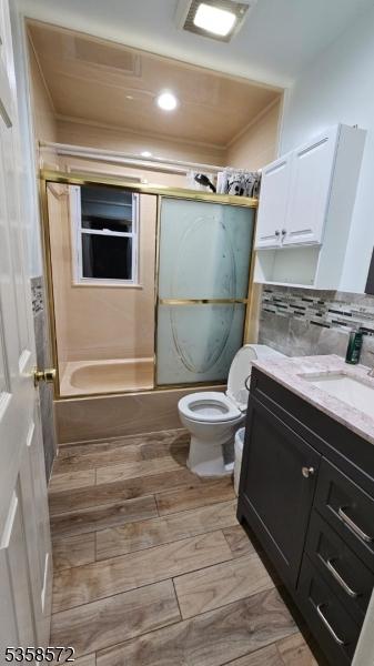 118 Prospect St, Franklin Twp, NJ 08873 - bathroom with toilet, vanity, shower / bath combination with glass door, recessed lighting, and wood finished floors