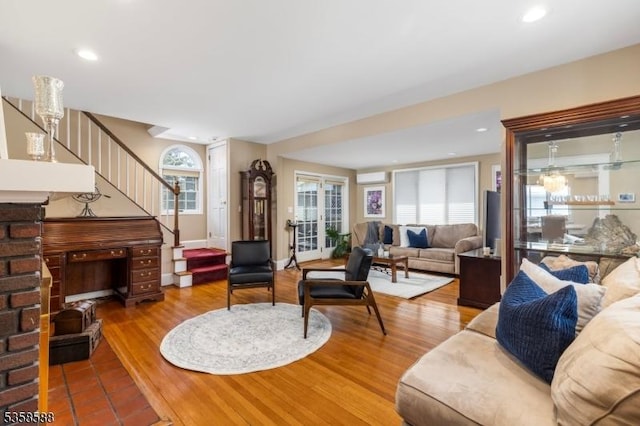 living area featuring stairway, recessed lighting, and wood finished floors