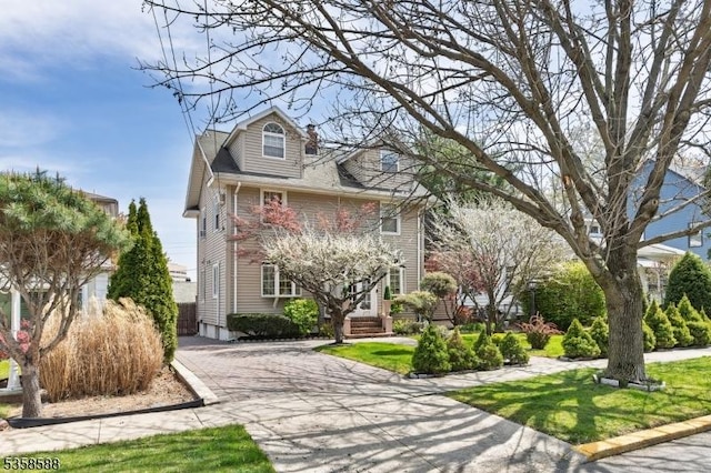 american foursquare style home with driveway