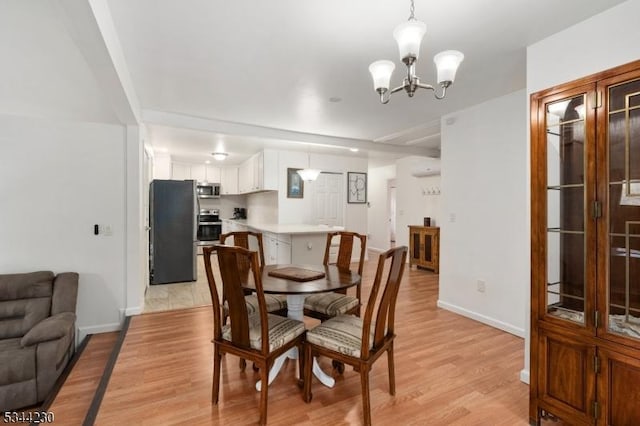 620 Hemlock Rd, Hampton Twp, NJ 07860 - dining space with light wood-style flooring, a chandelier, and baseboards