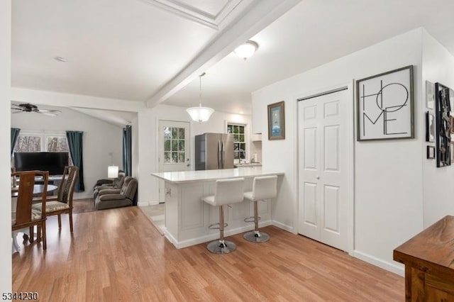 620 Hemlock Rd, Hampton Twp, NJ 07860 - kitchen with freestanding refrigerator, a peninsula, a kitchen breakfast bar, light countertops, and light wood-style floors
