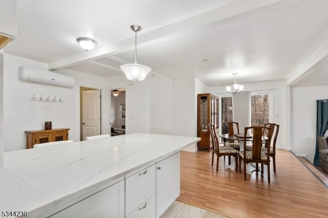 620 Hemlock Rd, Hampton Twp, NJ 07860 - kitchen with a wall mounted air conditioner, white cabinetry, decorative light fixtures, light stone countertops, and beamed ceiling
