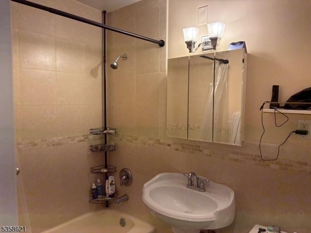 100 Manhattan Ave, Union City, NJ 07087 - bathroom with a sink, shower / bathtub combination with curtain, tasteful backsplash, and tile walls