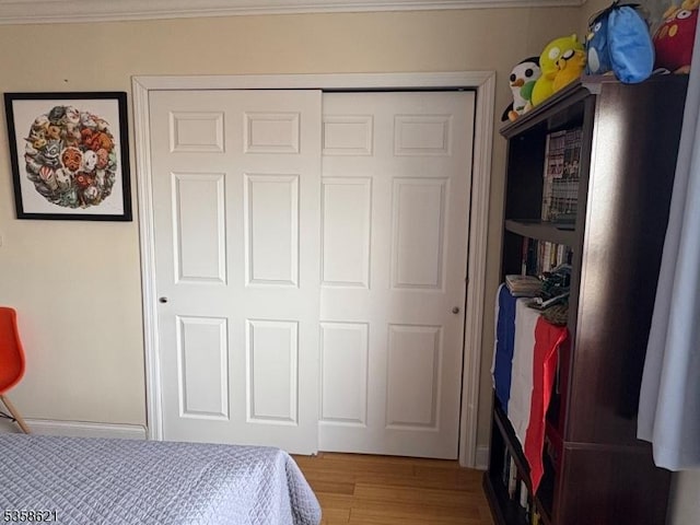 100 Manhattan Ave, Union City, NJ 07087 - bedroom with ornamental molding, a closet, and wood finished floors