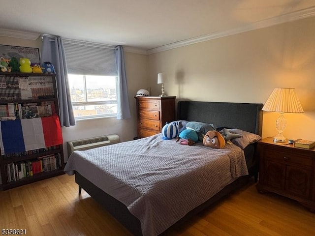 100 Manhattan Ave, Union City, NJ 07087 - bedroom with wood finished floors, ornamental molding, and a wall unit AC