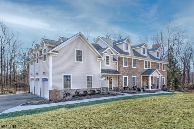 146 Mountainside Rd, Mendham Boro, NJ 07945 - view of front of house with a garage, asphalt driveway, a front lawn, stone siding, and a chimney