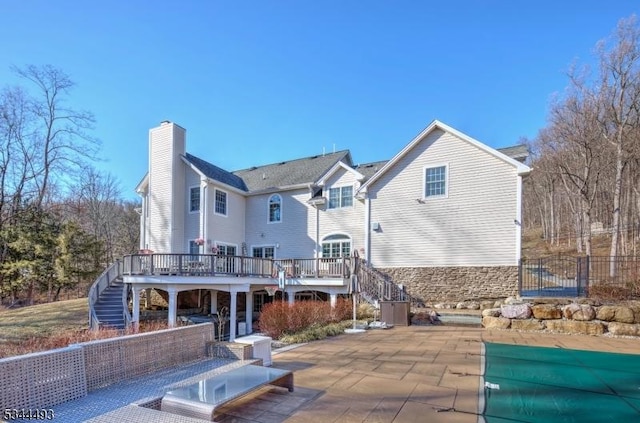 146 Mountainside Rd, Mendham Boro, NJ 07945 - back of house with stairs, a wooden deck, a patio area, and a chimney
