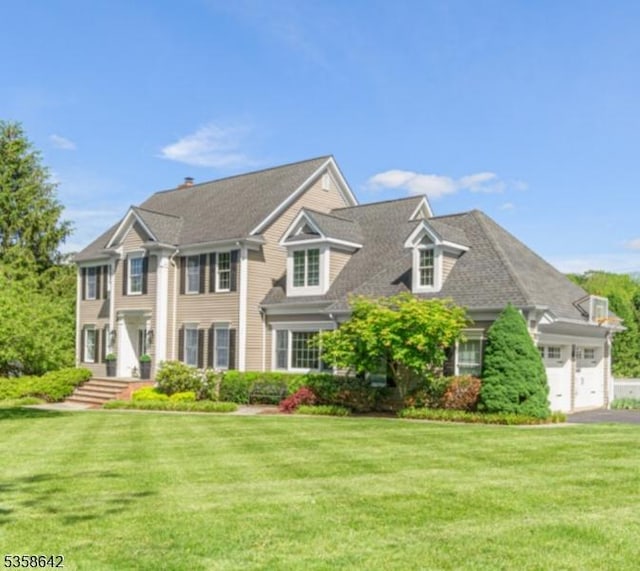 11 Brookside Dr, Peapack Gladstone Boro, NJ 07934 - view of front of house featuring a front lawn, a garage, and driveway