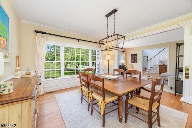 11 Brookside Dr, Peapack Gladstone Boro, NJ 07934 - dining room featuring ornamental molding, light wood-style flooring, stairway, and a chandelier
