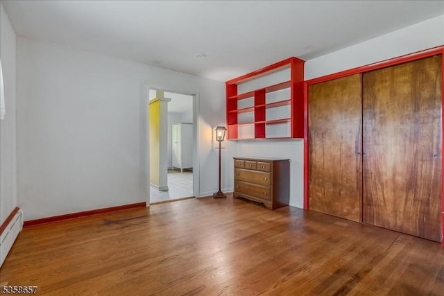 18 Pottersville Rd, Peapack Gladstone Boro, NJ 07934 - unfurnished living room featuring wood finished floors and a baseboard heating unit