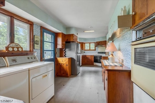 18 Pottersville Rd, Peapack Gladstone Boro, NJ 07934 - kitchen featuring white appliances, independent washer and dryer, decorative backsplash, brown cabinets, and light countertops