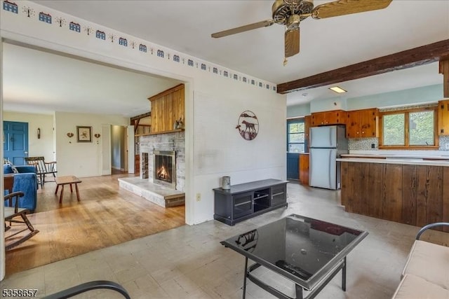 18 Pottersville Rd, Peapack Gladstone Boro, NJ 07934 - living area with a stone fireplace, a ceiling fan, and beamed ceiling