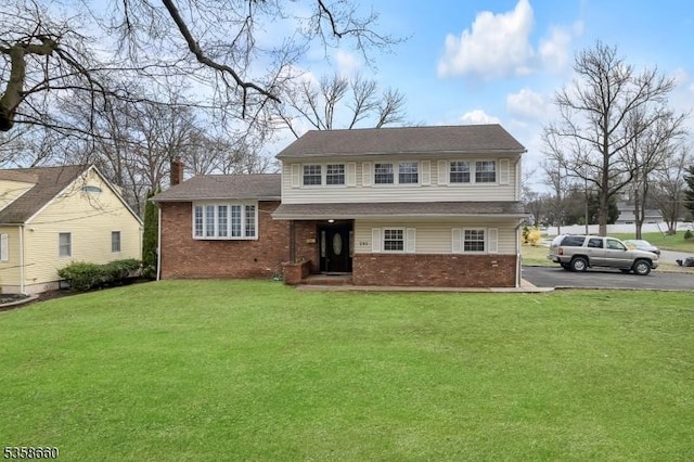 293 Oak Ridge Rd, Clark Twp, NJ 07066 - tri-level home with brick siding, a front yard, and asphalt driveway