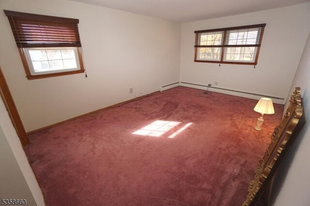293 Oak Ridge Rd, Clark Twp, NJ 07066 - carpeted spare room featuring healthy amount of natural light, a baseboard heating unit, and baseboards