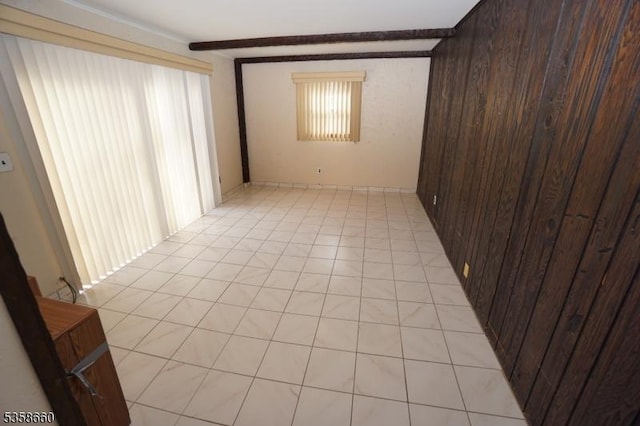 293 Oak Ridge Rd, Clark Twp, NJ 07066 - spare room featuring light tile patterned floors, wood walls, and beamed ceiling